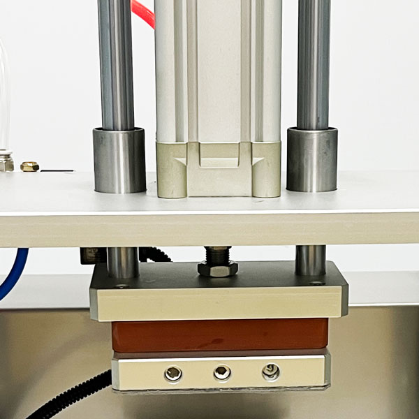 Pneumatic cylinder, guide rods and heated plate on laboratory pod machine